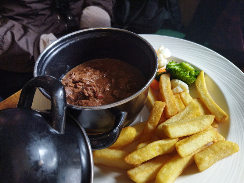 Rich Flemish stew with beef, braissed long chopper stout with fries and veggie